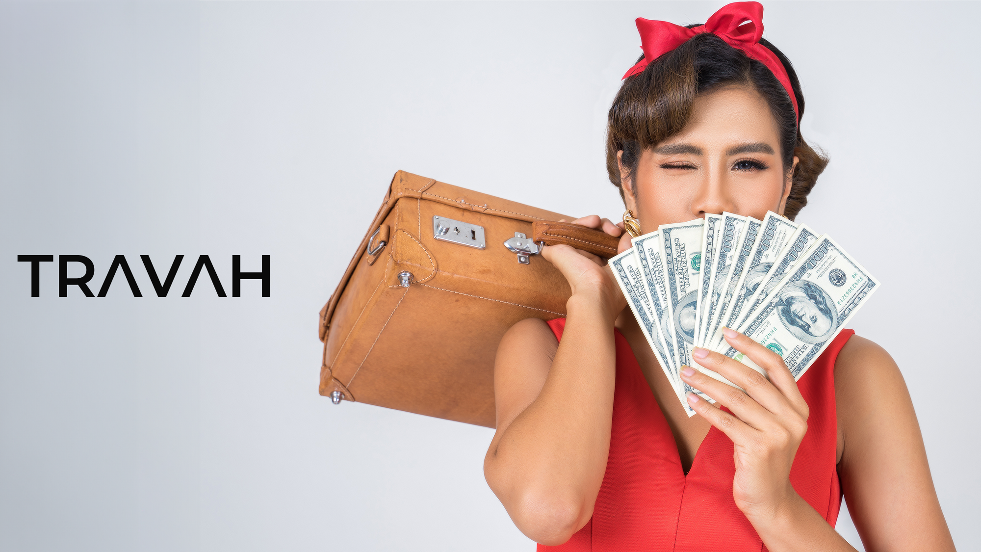 happy asian woman carrying a suitcase with money in front of her face