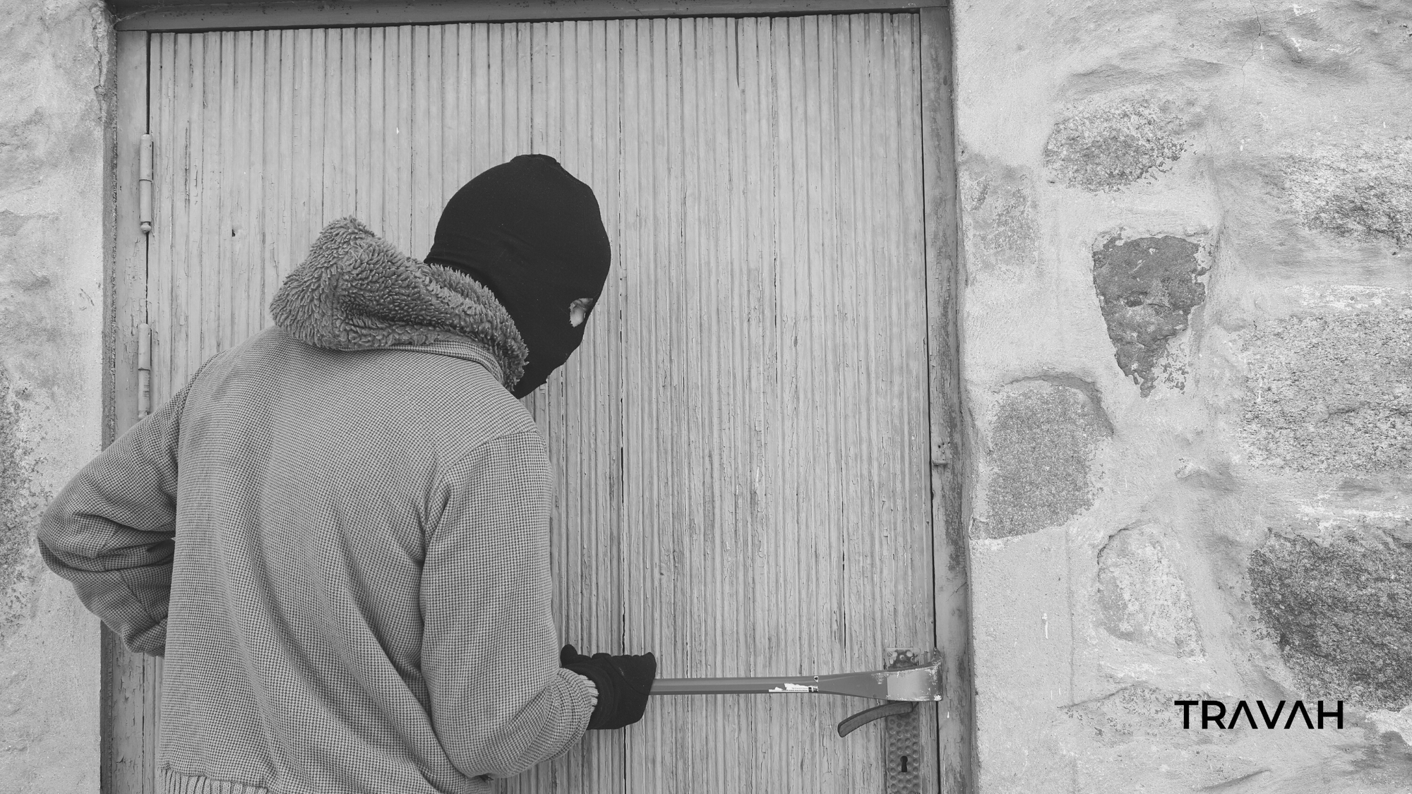 burglar breaking into door of house